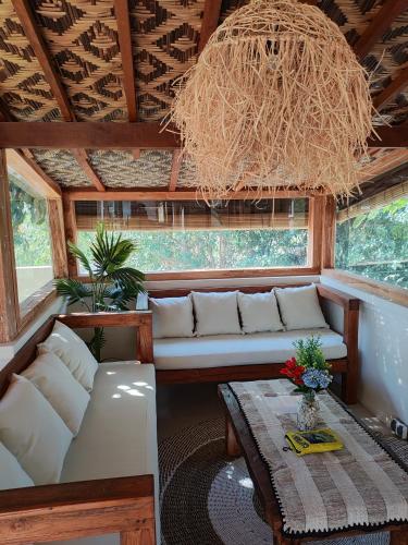 a living room with a couch and a table at Joglow Clasica Uluwatu in Uluwatu