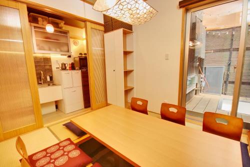 a dining room with a wooden table and chairs at TokyoKoso Vacation Home in Tokyo