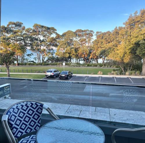 a view of two cars driving on a road at Huskisson Beach Motel in Huskisson