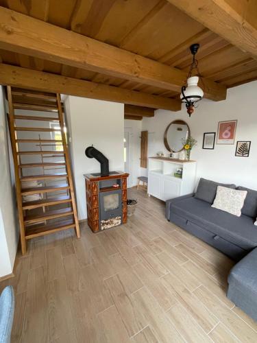 a living room with a couch and a wood stove at Wine & Relax Mezi Sklepy in Valtrovice
