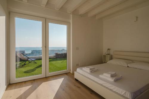 a bedroom with a bed and a large window at Casanova Bluelife in Trieste