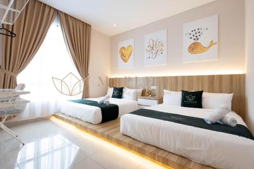 a bedroom with two beds and a window at KSL Residences 2 Premier Suites Johor Bahru in Johor Bahru