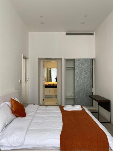 a bedroom with a large white bed and a desk at River House Near The Peoples Square And The Bund in Shanghai