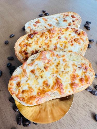 three slices of cheese pizza on a plate on a table at V1 boutique hotel in Kanchanaburi