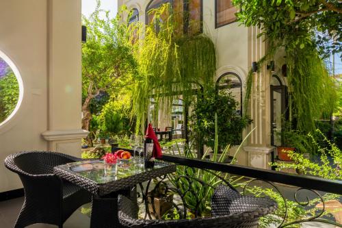 a patio with a table and chairs on a balcony at Green Tea Villa in Hoi An
