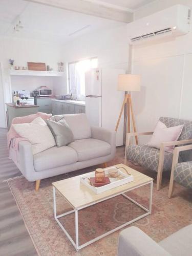 a living room with a couch and a coffee table at Willows Cottage on Anzac in Stanthorpe