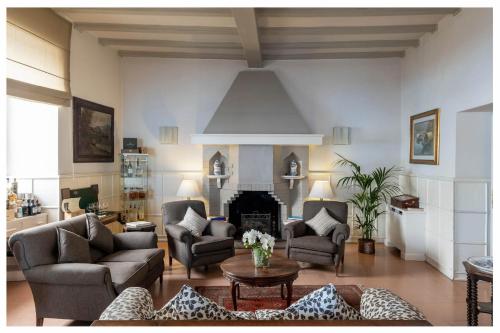 a living room filled with furniture and a fireplace at Albergo Ristorante Il Verbano in Stresa