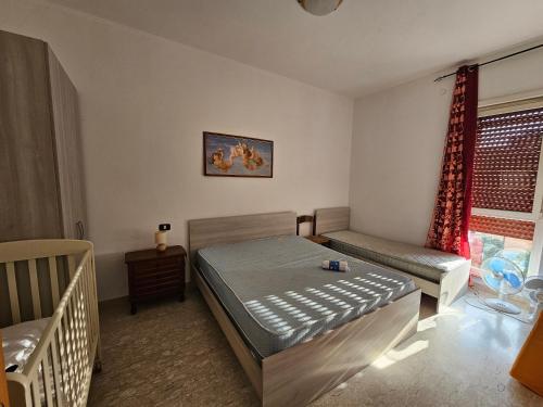 a bedroom with a bed and a couch and a window at Appartamento Da Concetta - Via Paolucci in Vasto