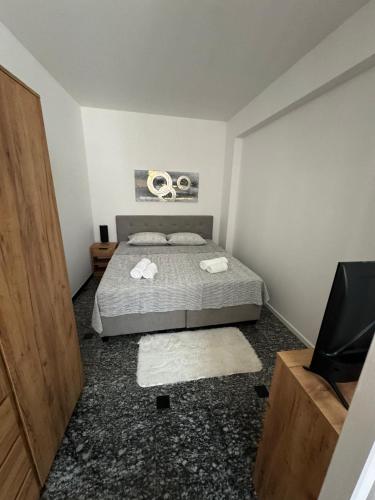 a bedroom with a bed with two towels on it at Centar in Krapina