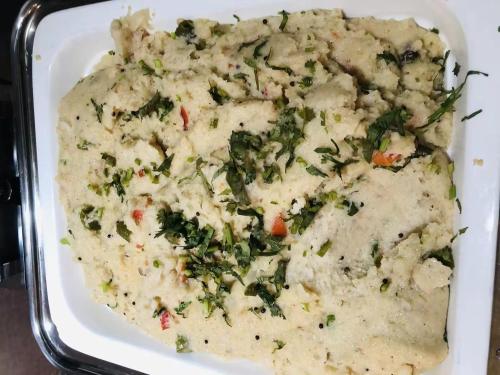 a white casserole dish filled with broccoli and cheese at Byland Star Hotel in Yiwu