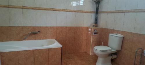 a bathroom with a toilet and a bath tub at R GARDEN Pointe Aux Sables in Pointe aux Sable