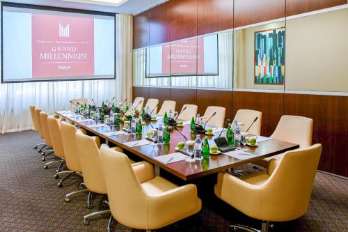 a conference room with a long table and chairs at Grand Millennium Tabuk in Tabuk