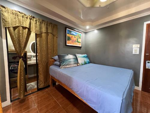 a bedroom with a bed in a room at Lovely Bedroom in Lila, Bohol with WIFI, AC and Ref in Lila