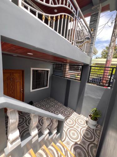 a staircase leading up to a house with a stair case at Lovely Bedroom in Lila, Bohol with WIFI, AC and Ref in Lila