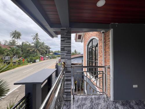 a balcony with a staircase leading to a building at Lovely Bedroom in Lila, Bohol with WIFI, AC and Ref in Lila