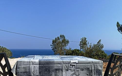an old suitcase sitting on top of two chairs at Agria Rigani Studios in Samos
