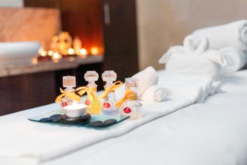 a tray of food and a cup of coffee on a bed at Grand Millennium Tabuk in Tabuk
