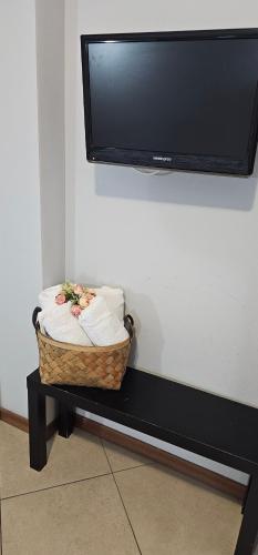 a wicker basket sitting on a table under a tv at Fiumicino Inn Airport in Fiumicino