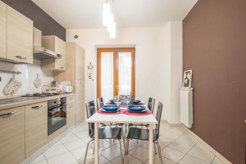 a kitchen with a table and chairs in a room at CASA.AD in Bracciano