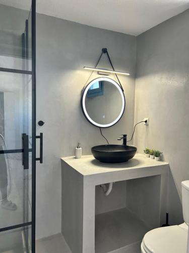 a bathroom with a sink and a mirror at Olive House in Márpissa