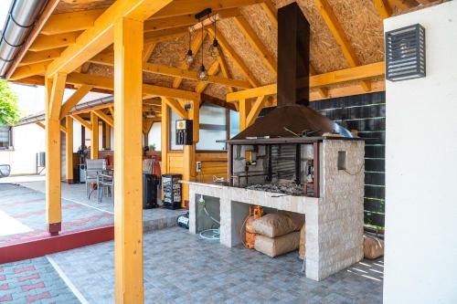 an outdoor kitchen with a brick oven on a patio at Relax Vučković in Ivanjica