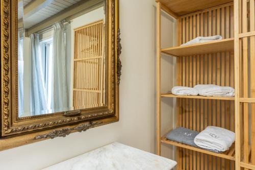 a bathroom with a mirror and shelves with towels at LDV ZANTE VILLAS - Luxury Dream Villa in Pandokrátor