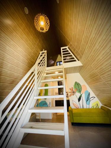 a staircase in a room with a couch at Tierra Bukid en Amadeo in Cavite