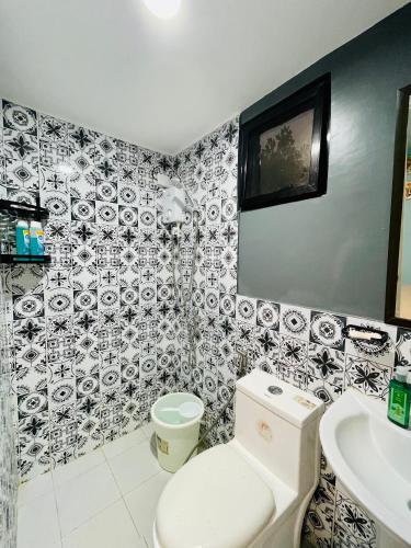 a bathroom with a toilet and a sink at Tierra Bukid en Amadeo in Cavite