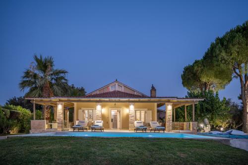 a home with a pool and a house at LDV ZANTE VILLAS - Luxury Dream Villa in Pandokrátor