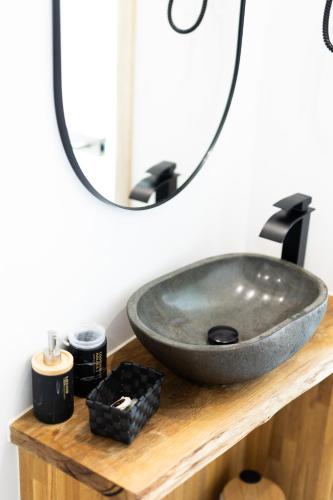 a bathroom sink on a wooden counter with a mirror at Nuit magique au château de Saint Vitu 101 in Tinlot