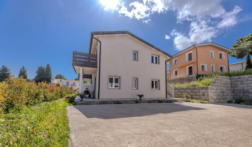 a house in the middle of a driveway at Camping Village Le Calanchiole in Capoliveri