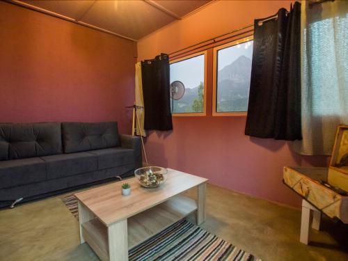 a living room with a couch and a table at VistaTzoumerka in Agnanta