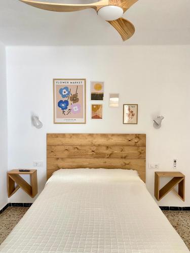 a bedroom with a white bed and a ceiling fan at Hotel Rural Casa Fina - Adults Recommended in Conil de la Frontera