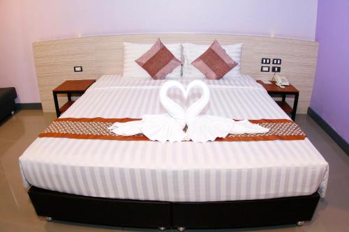 a bedroom with a bed with a heart decoration on it at Arthitaya Green Nature Hotel & Lakkhana Poolside Resort in Pattaya North