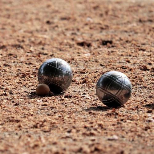 two balls sitting on the ground on a baseball field at Camping de la Piscine in Aigle