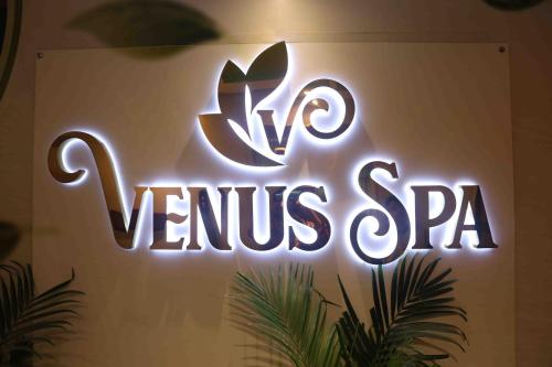 a neon sign that says no venus spa on a wall at City Tower Hotel in Fujairah
