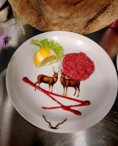 a plate of food with red food on it at Chalet BRAGARD in Limone Piemonte