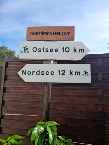 a street sign with three signs on it at Holiday apartment & boat rental in Sindal