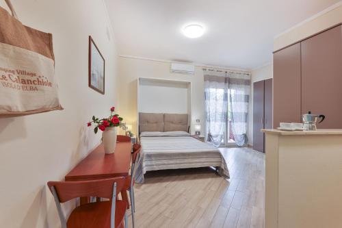 a living room with a bed and a table at Camping Village Le Calanchiole in Capoliveri