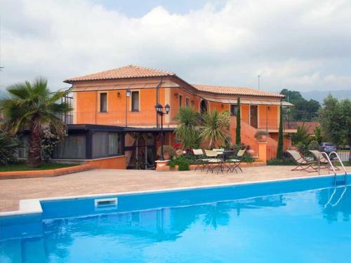 a house with a swimming pool in front of a house at Albergo Arinde in Rende