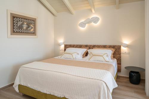 a bedroom with a large bed with white sheets and pillows at Nelia Suite in Lixouri