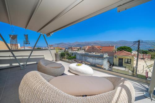 a balcony with chairs and a table and a view at Nelia Suite in Lixouri