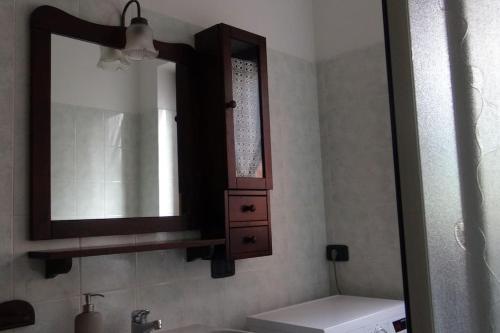 a bathroom with a mirror and a sink at Chalet Belvedere in Costa di Serina
