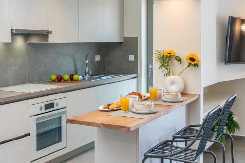 a kitchen with a table with food and orange juice at Nelia Suite in Lixouri