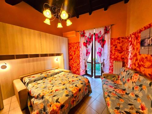 a bedroom with a large bed and a window at La Corte dei Fiori in Albavilla