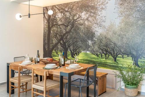 a dining room with a table and chairs and a window at Nelia Suite in Lixouri