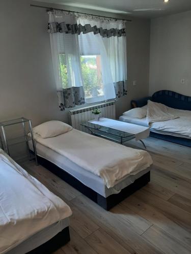 a room with three beds and a window at Zielone Zacisze in Zagnańsk