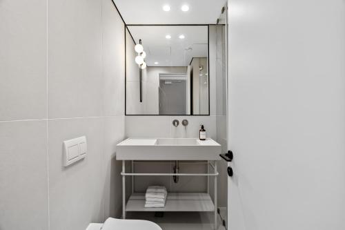 a bathroom with a sink and a mirror at Hotel 48 in Beer Sheva