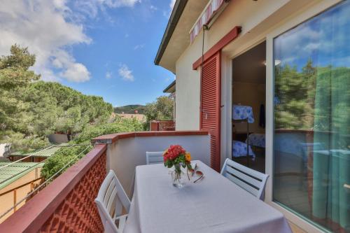 a vase of flowers on a table on a balcony at Camping Village Le Calanchiole in Capoliveri