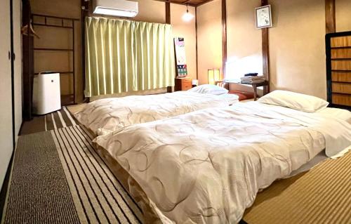 Кровать или кровати в номере Guesthouse Naramachi